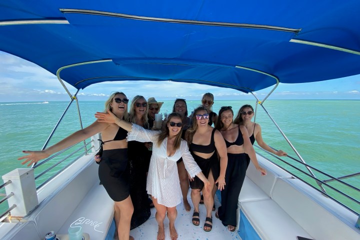 a group of people standing next to a body of water