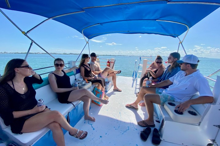 a group of people sitting at a beach