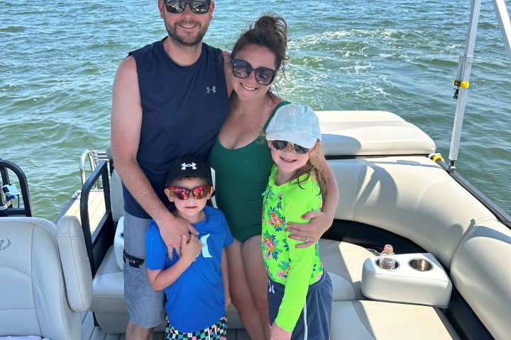 a man and a woman sitting on a boat in a body of water