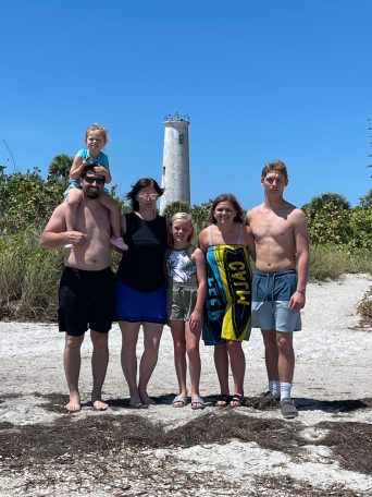 a group of people standing on a beach