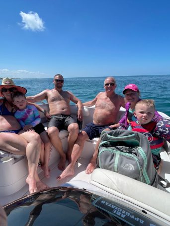 a group of people in a boat on a body of water