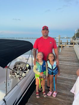 a man standing on a beach posing for the camera
