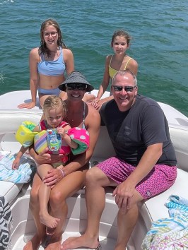 a group of people sitting on a boat in the water