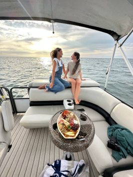 a woman sitting on a boat in the water