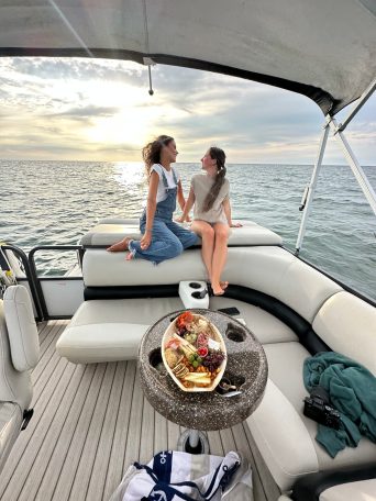 a woman sitting on a boat in the water