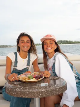 a woman sitting on a boat in a body of water