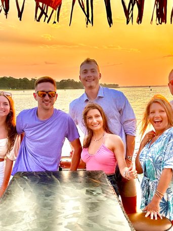 a group of people standing next to a body of water