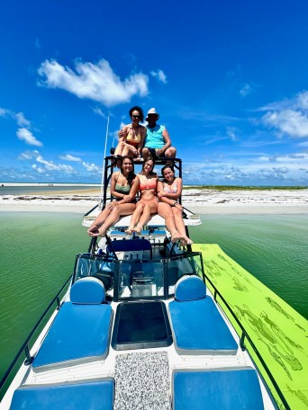 a man riding on the back of a boat in the water