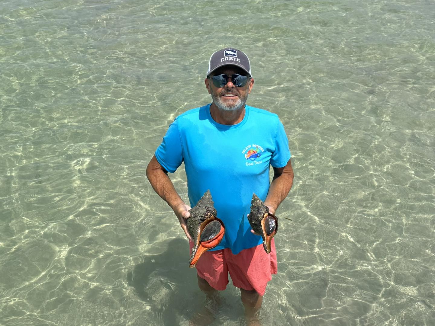 a man standing next to a body of water
