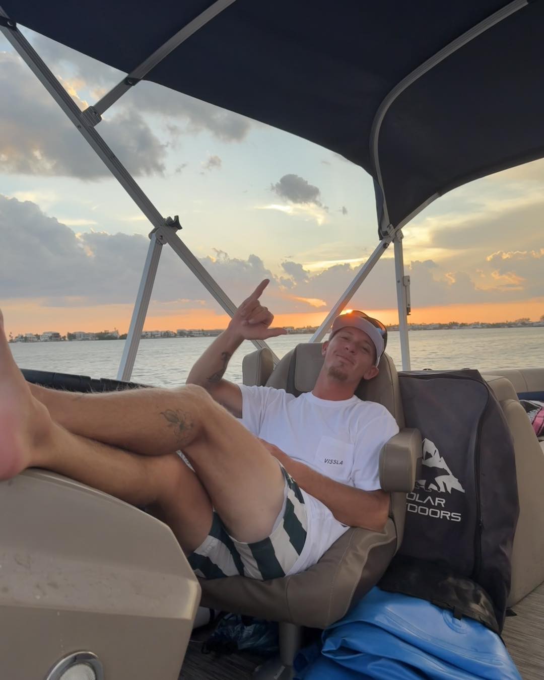 a man standing next to a body of water